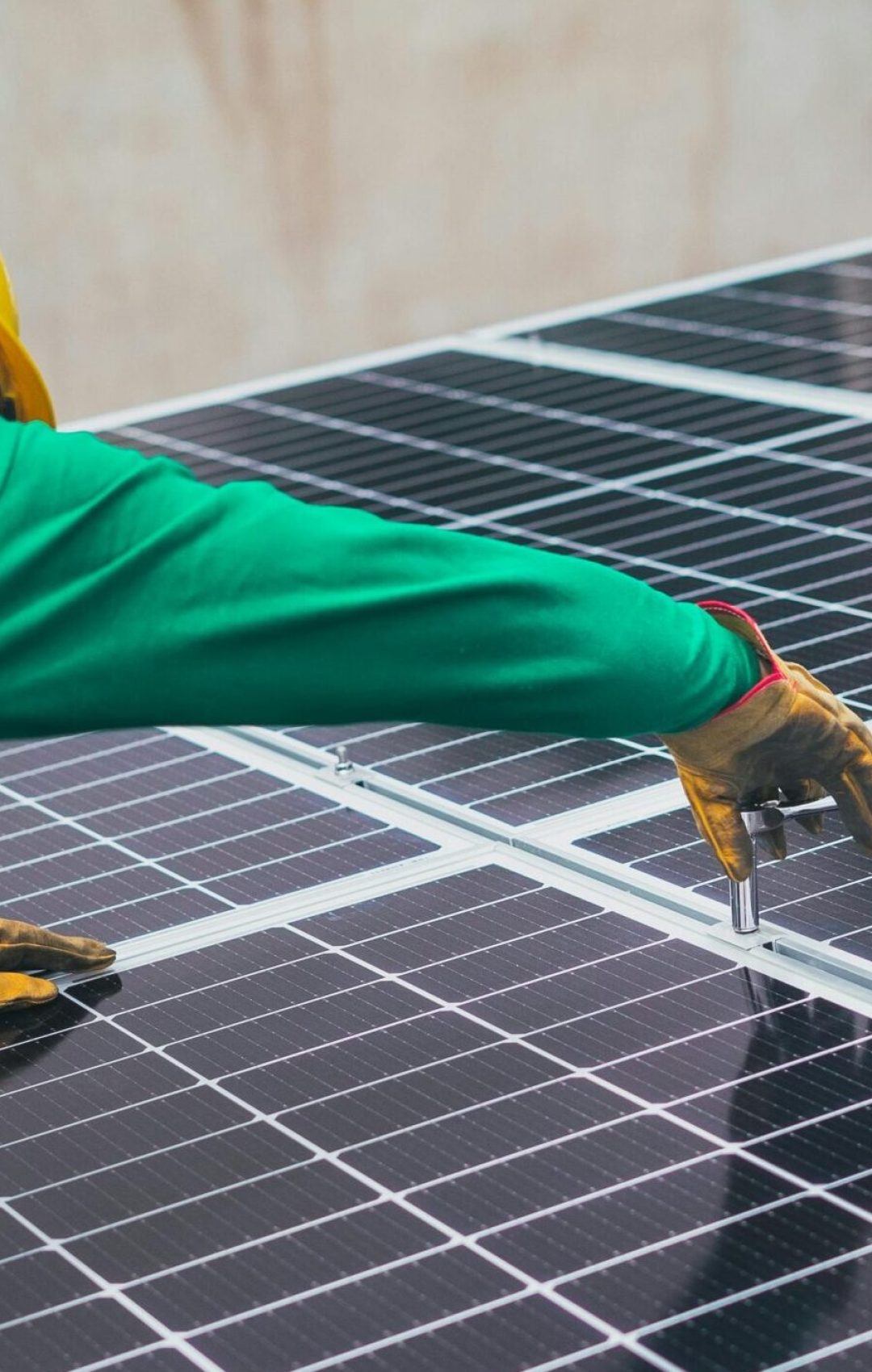 Technician installing solar panels on a rooftop for sustainable energy solutions.